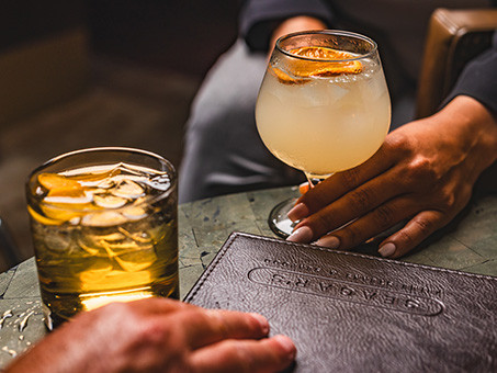 Drinks on a table next to a menu