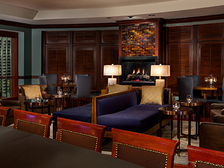 An intimate bar with a fireplace crackling in the background